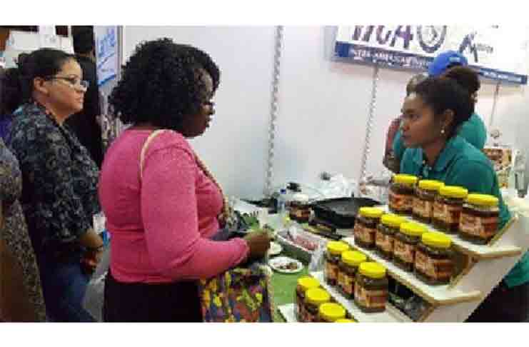 Customers survey some of the offerings of an agribusiness during the October 4-8 Caribbean Week of Agriculture, jointly hosted by the Inter-American Institute for Cooperation on Agriculture and the Caribbean AgriBusiness Association.