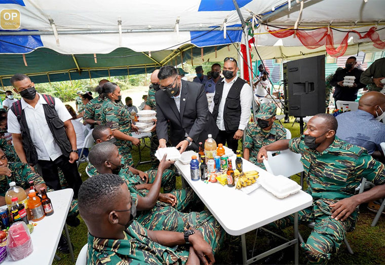 President Irfaan Ali distributing meals to GDF ranks