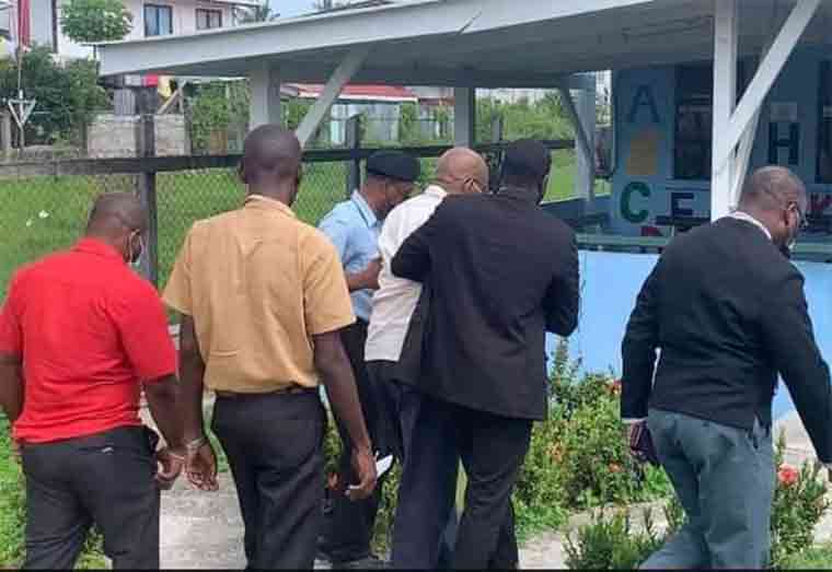 Former Finance Minister Winston Jordan being assisted into the Plaisance Health Centre