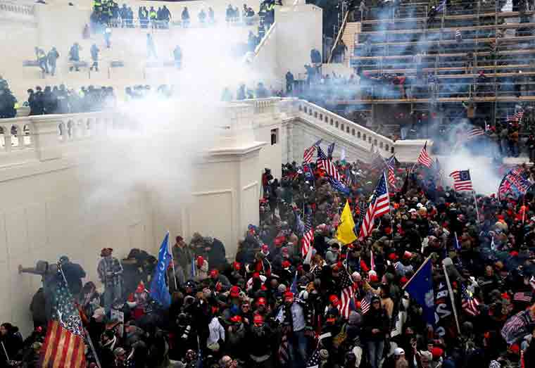 Police release tear gas into a crowd of pro-Trump protesters during clashes at a rally to contest the certification of the 2020 U.S. presidential election results by the U.S. Congress, at the U.S. Capitol Building in Washington, U.S, January 6, 2021. REUTERS/Shannon Stapleton/File Photo