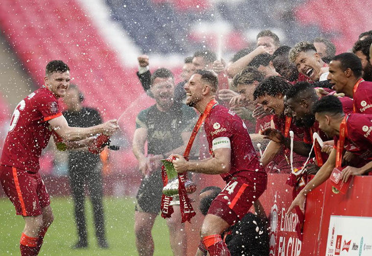 Liverpool players celebrate at the end of the English FA Cup final soccer match between Chelsea and Liverpool, at Wembley stadium, in London, Saturday, May 14, 2022.