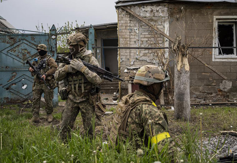 Ukrainian National Guard patrol during a reconnaissance mission in a recently retaken village on the outskirts of Kharkiv, east Ukraine, Saturday, May 14, 2022. (AP Phot0)