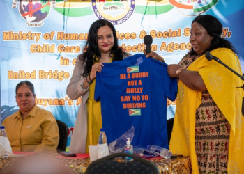 Human Services and Social Security Dr Vindhya Persaud receiving an anti-bullying t-shirt from Bonita Montaque