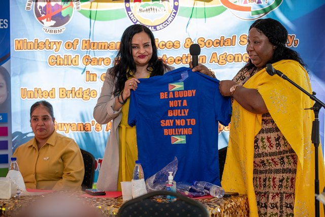 Human Services and Social Security Dr Vindhya Persaud receiving an anti-bullying t-shirt from Bonita Montaque