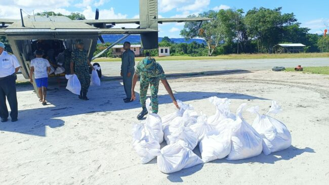Food hampers being offloaded from the plane (DPI Photo)