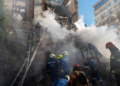 Firefighters work after a drone fired on buildings in Kyiv, Ukraine, Monday, October 17, 2022. (AP Photo/Roman Hrytsyna)