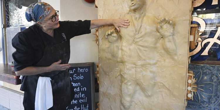 Catherine Pervan, with Our House Bakery in Benicia, Calif., talks about creating the life-sized Han Solo on Oct. 13, 2022 . The piece is the bakery's entry in the downtown Benicia scarecrow contest. (Chris Riley/The Times-Herald via AP)