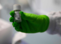 An employee holds up a vial of an oncological product under development, at the BioNTech research institute in Mainz, Rhineland-Palatinate, western Germany, on Oct. 5, 2022.