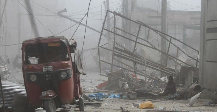 Injured civilians are seen at the scene of an explosion near the education ministry building along K5 street in Mogadishu