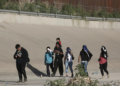 A group of Venezuelan migrants walks toward the United States border to surrender to the border patrol in Ciudad Juarez, Mexico