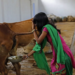 Susheela Kumari, an attendant at a cow shelter, collects urine to be processed in Bulandshahar, Uttar Pradesh, India.