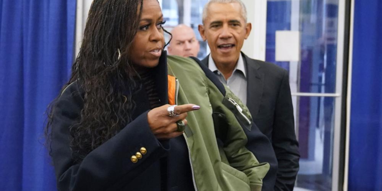 Former first lady Michelle Obama, left, and former President Barack Obama arrive to cast their ballots at an early voting site Monday, Oct. 17, 2022, in Chicago. (AP Photo/Charles Rex Arbogast)