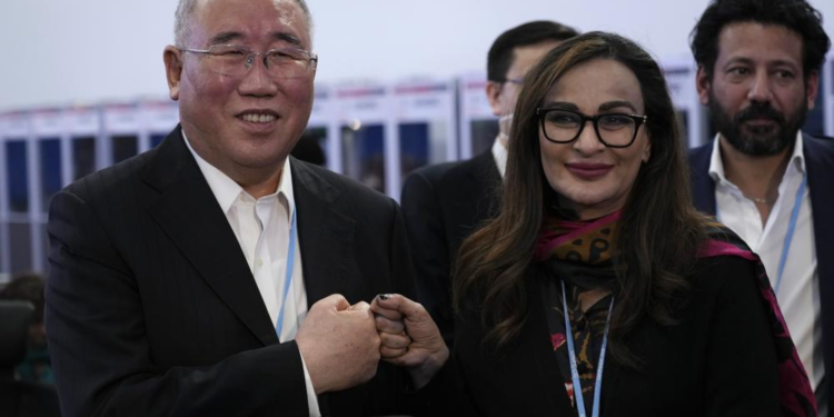 Xie Zhenhua, China's special envoy for climate, left, and Sherry Rehman, minister of climate change for Pakistan, pose for photos during a break in a closing plenary session at the COP27 U.N. Climate Summit, Sunday, Nov. 20, 2022, in Sharm el-Sheikh, Egypt.