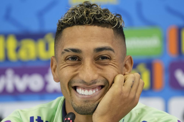 Brazil's Raphinha smiles during a press conference after a training session at the Grand Hamad stadium in Doha, Qatar, Monday, Nov. 21, 2022. Brazil will play their first match in the World Cup against Serbia on Nov. 24. (AP Photo/Andre Penner)