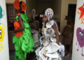 Jalokun Nifemi, wearing an outfit made from recycled newspapers, waits back stage before a 'trashion show' in Sangotedo Lagos, Nigeria, Saturday, Nov. 19, 2022. (AP Photo/Sunday Alamba)