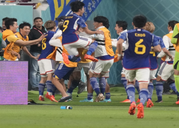 Japan players celebrate after Takuma Asano scored his side's second goal during the World Cup Group E match against Germany, at the Khalifa International Stadium in Doha, Qatar, Wednesday, Nov. 23, 2022. (AP Photo/Eugene Hoshiko).