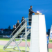 The ceremonial lighting of the cauldron was conducted by the defending champions from District Ten
