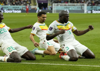 Senegal's Kalidou Koulibaly, right, celebrates with teammates after scoring his side's second goal during the World Cup Group A football match against Ecuador at the Khalifa International Stadium in Doha, Qatar, Tuesday, Nov. 29, 2022. (AP Photo/Francisco Seco).