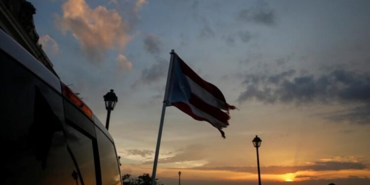 A tattered flag of Puerto Rico flies from a truck parked in the Hurricane Maria affected area of Old San Juan, Puerto Rico. 
REUTERS/Shannon Stapleton