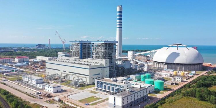 This aerial photo taken on Dec. 16, 2022 shows the Huadian Preah Sihanouk 2×350 MW Coal-fired Power Plant in Preah Sihanouk province, Cambodia. The Huadian Preah Sihanouk coal-fired power plant in Cambodia on Friday passed a commissioning test successfully and was officially put into operation, becoming the largest power generation project in the country.(Photo by Li Xinlin/Xinhua)