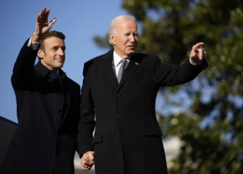President Joe Biden and French President Emmanuel Macron stand on the stage during a State Arrival Ceremony on the South Lawn of the White House in Washington, Thursday, Dec. 1, 2022. (AP Photo/Andrew Harnik)
