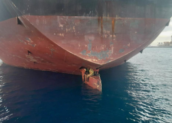 In this photo released by Spain's Maritime Safety and Rescue Society on Tuesday Nov. 29, 2022, three men are photographed on an oil tanker anchored in the port of the Canary Islands, Spain. Spain’s Maritime Rescue Service says it has rescued three stowaways traveling on a ship’s rudder in the Canary Islands after the vessel sailed there from Nigeria. The men were found on the Alithini II oil tanker at the Las Palmas port. (Salvamento Maritimo via AP)