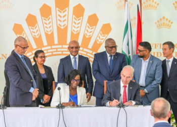 President, Irfaan Ali, Prime Minister Mark Phillips, Vice President Bharrat Jagdeo and other officials observe as Permanent Secretary in the Office of the President, Ms. Abena Moore and Mr John Hess sign the agreement