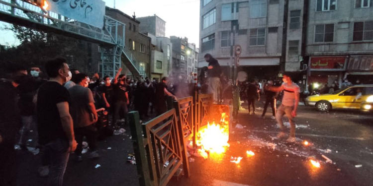 People light a fire during a protest over the death of Mahsa Amini, a woman who died after being arrested by the Islamic republic's "morality police", in Tehran, Iran September 21, 2022. WANA (West Asia News Agency) via REUTERS