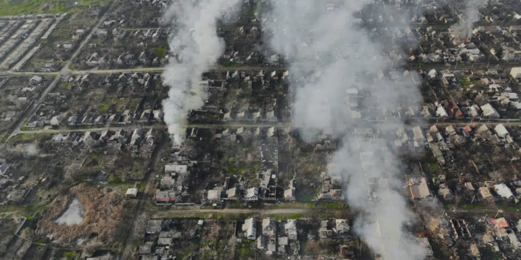 Smoke billows after Russian attacks in the outskirts of Bakhmut, Ukraine, Tuesday, Dec. 27, 2022. (AP Photo/Libkos)