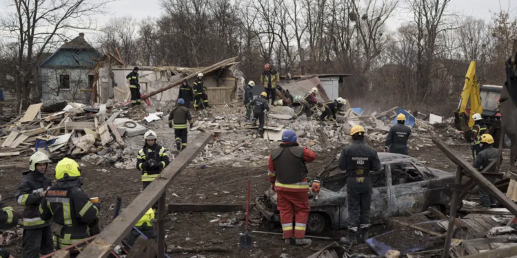 Emergency workers remove debris of a house destroyed following a Russian missile strike in Kyiv, Ukraine, Thursday, Dec. 29, 2022. (AP Photo/Roman Hrytsyna)