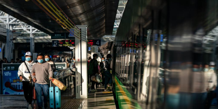 Passengers get on a train of the China-Laos Railway at Kunming Railway Station in Kunming, southwest China's Yunnan Province, Nov. 23, 2022. As of Friday, the China-Laos Railway has handled over 8.5 million passenger trips and transported 11.2 million tonnes of cargo since its launch a year ago, the Chinese railway operator said. (Xinhua/Hu Chao)