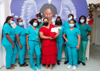 First Lady with Christmas baby and staff of maternity ward