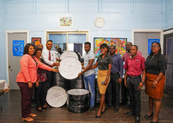 Deputy Chief Education Officer (Technical), Dr. Ritesh Tularam handing over the instruments to representatives of the schools.