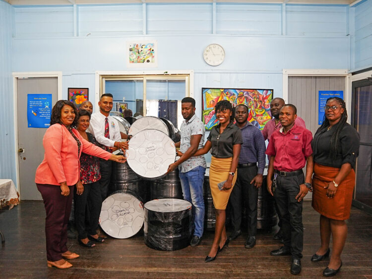 Deputy Chief Education Officer (Technical), Dr. Ritesh Tularam handing over the instruments to representatives of the schools.
