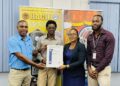 (L-R) BACIF's Operations Manager Rondel Ali and Quality Manager Adrian Barkoye receives certificate from Head of GNBS Certification Dept. Ms. Andrea Mendonca and Technical Officer Orlando Sturge
