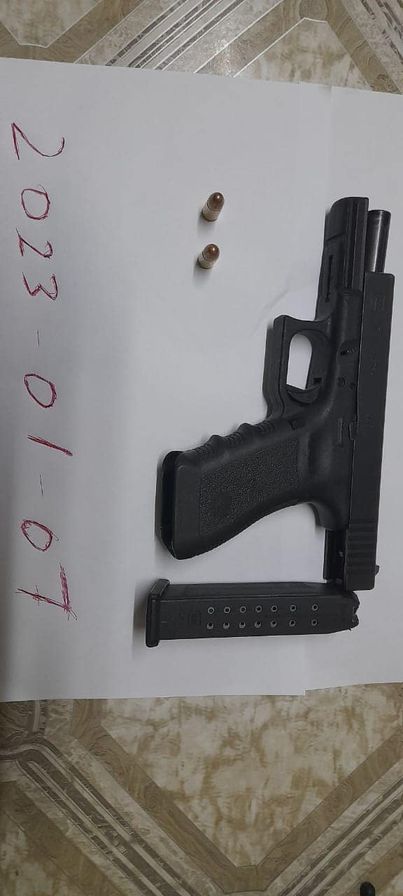 The arm and ammunition Police said they found (Police photo)