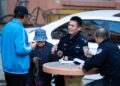 File photo shows a policeman talking with residents at a community in Harbin, northeast China's Heilongjiang Province (XINHUA)