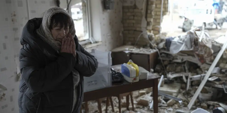 Halina Panasian, 69, reacts inside her destroyed house after a Russian rocket attack in Hlevakha, Kyiv region, Ukraine, Thursday, Jan. 26, 2023. (AP Photo/Roman Hrytsyna)