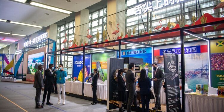 People visit an exhibition during the 14th China-Latin America and the Caribbean Business Summit in southwest China's Chongqing on Nov. 16, 2021. (Xinhua/Tang Yi)