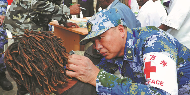 A doctor from Peace Ark, a hospital ship operated by the PLA Navy, provides medical treatment at the Maputo School for the Disabled in Maputo, Mozambique, in November 2017. JIANG SHAN/FOR CHINA DAILY