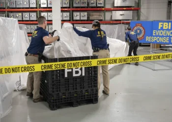 FILE - In this image provided by the FBI, FBI special agents assigned to the evidence response team process material recovered from the high altitude balloon recovered off the coast of South Carolina, Feb. 9, 2023, at the FBI laboratory in Quantico, Va. The United States on Friday, Feb. 10 blacklisted six Chinese entities it said were linked to Beijing's aerospace programs as part of its retaliation over an alleged Chinese spy balloon that traversed the country's airspace. (FBI via AP, File)