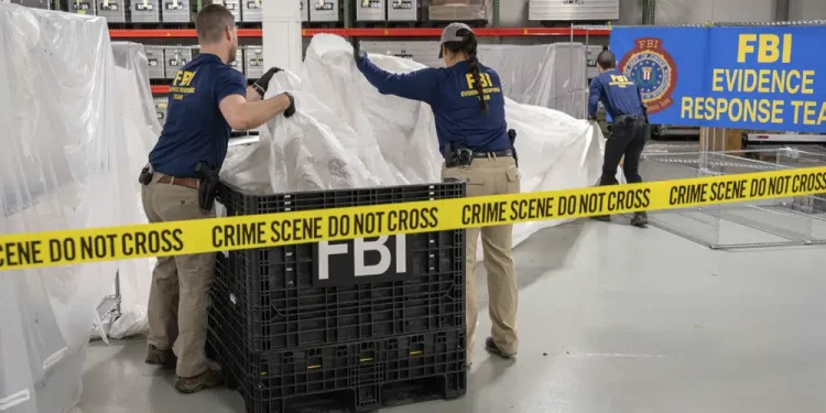 FILE - In this image provided by the FBI, FBI special agents assigned to the evidence response team process material recovered from the high altitude balloon recovered off the coast of South Carolina, Feb. 9, 2023, at the FBI laboratory in Quantico, Va. The United States on Friday, Feb. 10 blacklisted six Chinese entities it said were linked to Beijing's aerospace programs as part of its retaliation over an alleged Chinese spy balloon that traversed the country's airspace. (FBI via AP, File)