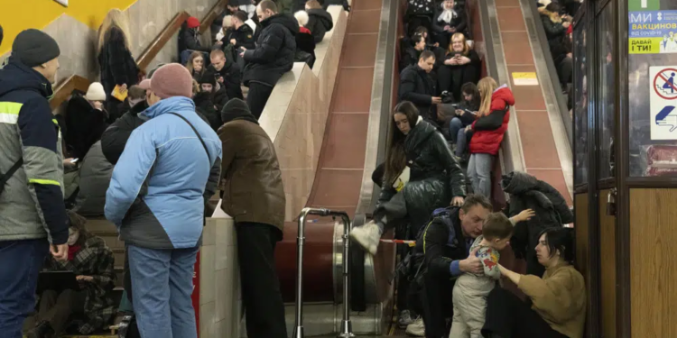 People gather in a subway station being used as a bomb shelter during a Russian rocket attack in Kyiv, Ukraine, Friday, Feb. 10, 2023. (AP Photo/Efrem Lukatsky)