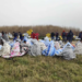 Rescued migrants sit covered in blankets at a beach near Cutro, southern Italy, Sunday, Feb. 26, 2023. Rescue officials say an undetermined number of migrants have died and dozens have been rescued after their boat broke apart off southern Italy. (Antonino Durso/LaPresse via AP)