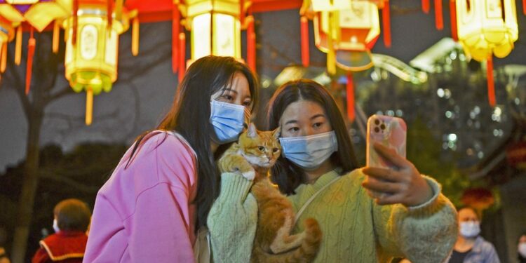 Tourists pose for photos with lanterns during a Lantern Festival fair held in the Nantou ancient town in Shenzhen, south China's Guangdong Province, on Feb. 4, 2023. (Xinhua/Liang Xu)