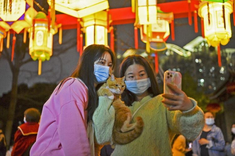 Tourists pose for photos with lanterns during a Lantern Festival fair held in the Nantou ancient town in Shenzhen, south China's Guangdong Province, on Feb. 4, 2023. (Xinhua/Liang Xu)