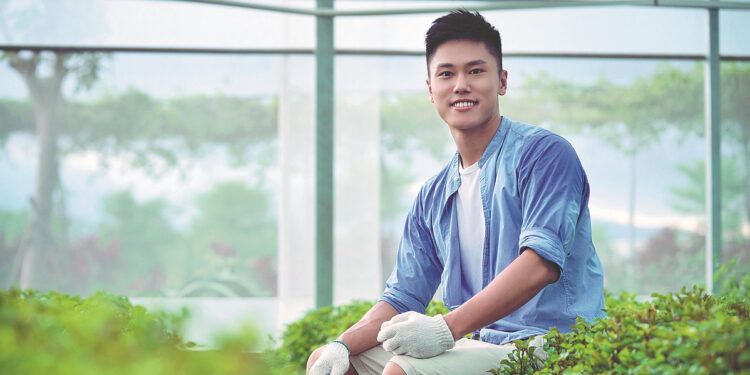 Victor Lo at the aquaponics farm he set up with two friends in Jiangmen, Guangdong province. China Daily