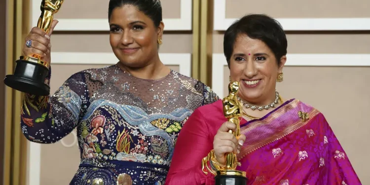 Kartiki Gonsalves, left, and Guneet Monga pose with the award for best documentary short film for "The Elephant Whisperer" in the press room at the Oscars on Sunday, March 12, 2023, at the Dolby Theatre in Los Angeles. (Photo by Jordan Strauss/Invision/AP)