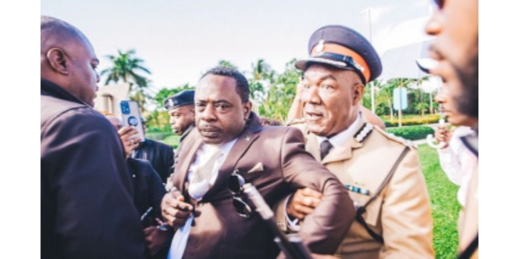Lincoln Bain being taken into police custody last month during a protest in The Bahamas. Photo: CMC