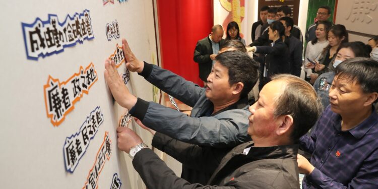 Local civil servants decorate a themed wall at an exhibition featuring combating corruption and building a clean government in Nantong, East China's Jiangsu Province. Photo: IC